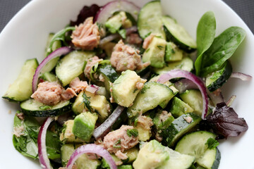 Healthy food. Cucumber tuna avocado salad. 