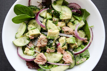 Healthy food. Cucumber tuna avocado salad. 