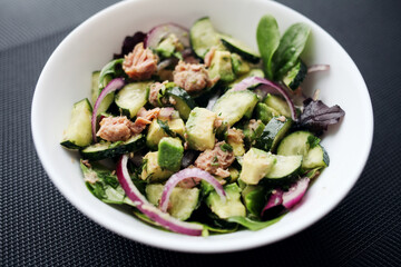 Healthy food. Cucumber tuna avocado salad. 