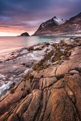 Sunset Norway landscape of picturesque stones on the arctic beach of cold Norwegian Sea
