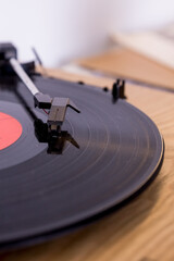 retro player with a vinyl disk on blurred background.Old gramophone turntable with disc.playing...