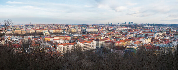 Naklejka na ściany i meble Aerial panorama view of Prague city centre cityscape and skyline with many historic and modern buildings and Vltava river, view from top of Petrin Hill. Czech Republic, winter day