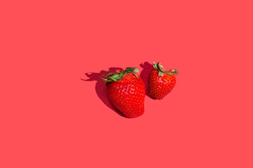 Top view of fresh strawberry isolated on red background.