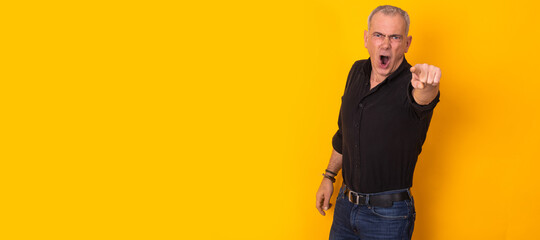 isolated man pointing and shouting on color background