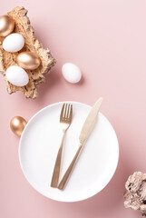 Easter table setting on a powdery background, vertical orientation, copy space