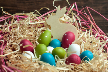 an easter bunny with wooden eggs in a basket