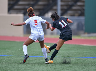 High school girls competing in a soccer match in south Texas