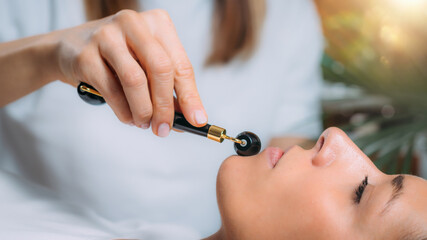 Fototapeta premium Guasha Face Massage with Jade Stone Roller