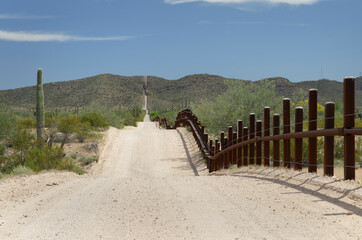 Fototapeta na wymiar USA, Arizona. Fence along the Mexican United States border, Organ Pipe Cactus National Monument.