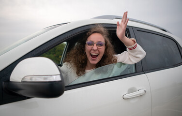 Angry woman gesturing with her hands while is driving a car. Woman is screaming