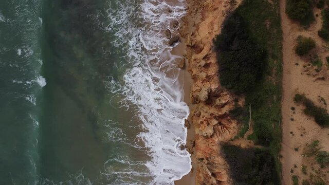 Aerial view of a beach with a cliff
