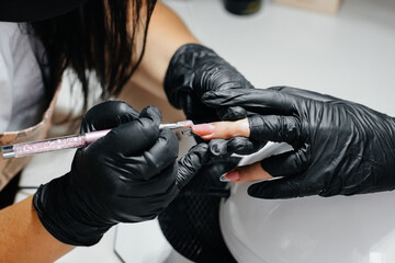 A young girl gets a close-up manicure on her hands in a beauty salon. Beauty salon