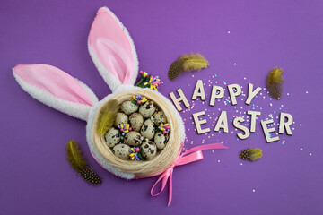 Easter background with eggs and toy rabbit ears on purple background