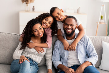 Portrait of a happy black family posing at camera