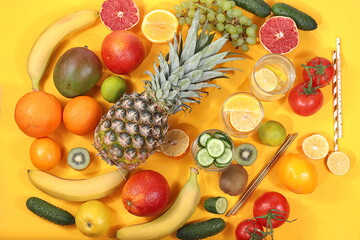 Detox diet and weight loss concept. Fruit drink and ingredients, summer tropical fruits and cocktails on a blue table, top view, healthy and natural food, source of vitamin C,