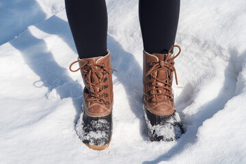 boots of a woman standing in the snow