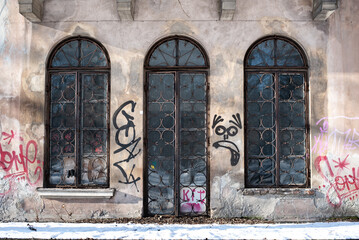 old  glass and metal door in the town with graffiti