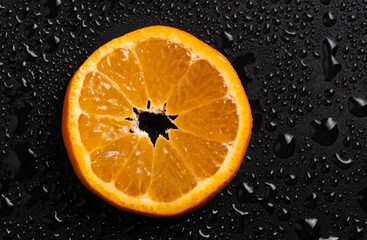 Mandarin slice, detailed closup against black background