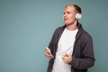 young man wearing casual white t-shirt isolated over blue background