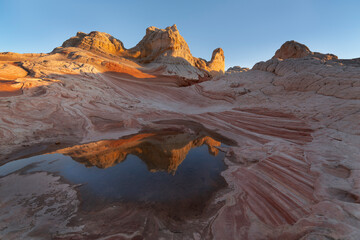 USA, Arizona, Vermilion Cliffs National Monument. Striations in sandstone formations and pool.