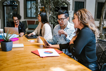 Latin business people discussing a project plan in office in Latin America