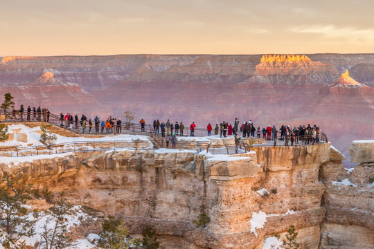 USA, Arizona, Grand Canyon National Park. Tourists watch sunrise on Mather Point.