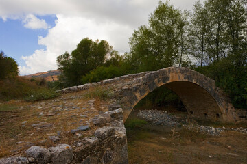 Fototapeta na wymiar Old Venetian-built Skarfos bridge over a dried up stream near Filoussa, Cyprus