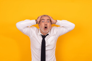 surprised adult man looking with hands on head isolated