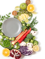 Empty plate with bright healthy vegetables on an isolated background Top view on a healthy, grocery background.