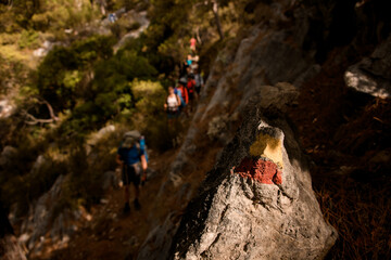 view on colorful symbol on stone marking Lycian hiking trail in Turkey.