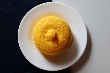 Brazilian Couscous on black background, with place for text. Typical food from the Northeast region of Brazil. Corn food.