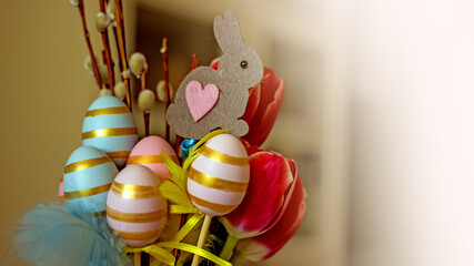 Easter creative home decoration a bouquet with decorative eggs, Easter paper bunnies, pussy willow 