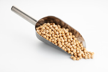Small Chickpea on metallic scoop isolated on White table. Cicer arietinum