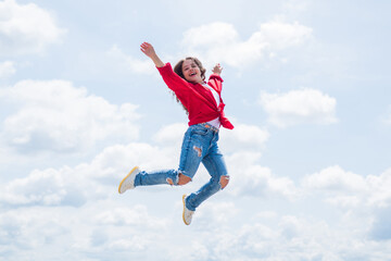 Fototapeta na wymiar happy energetic kid feeling free and jumping high, freedom