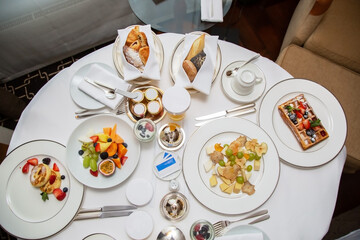 Served breakfast in a hotel room on a roll-out table on a white tablecloth