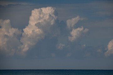 Naklejka na ściany i meble beautiful view of white clouds in sky above the ocean horizon line