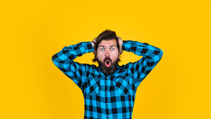 mature guy with moustache on face. expressing human emotions. scared man in checkered shirt. emotional man on yellow background. brutal bearded hipster. oh no