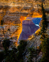 USA, Arizona, Grand Canyon National Park. View through hole in canyon wall at sunrise.