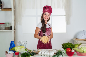 nutrition value. choosing a career. little helper knead dough. culinary and cuisine. happy childhood. happy child wear cook uniform. chef girl in hat and apron. kid cooking food in kitchen