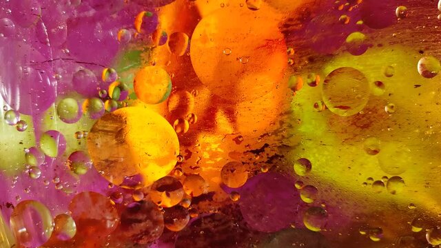 chaotically moving multicolored bubbles in a viscous liquid substance. 
