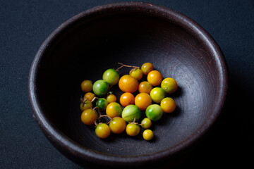 variety of tomatoes ripening on plate