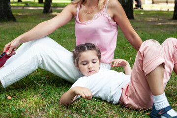 Fototapeta premium young pretty mother walking with little cute daughter outside in green park, lifestyle poeple concept