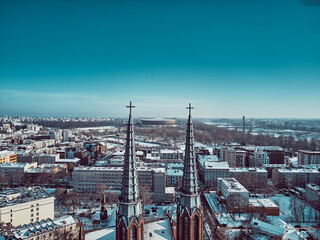 Beautiful panoramic aerial drone view of the stadium through two church towers - St. Florian's Cathedral, Warsaw, Poland, EU