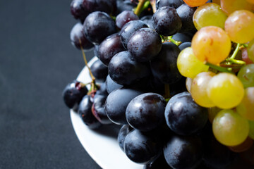 Grape bunch on white plate