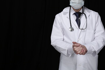 Doctor with stethoscope on black background