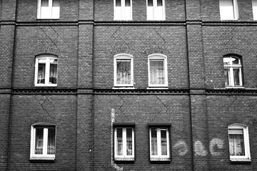 Windows in the brick facade of a historic house