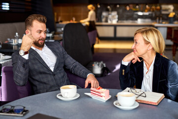 two thoughtful business partners sit together, thinking about business ideas and steps for successful work