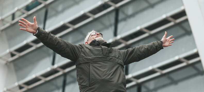 A Breath Of Freedom. Senior Man Spread His Arms Outdoors. Carefree Life In Old Age.