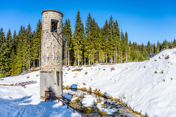 Broken dam in winter mountains