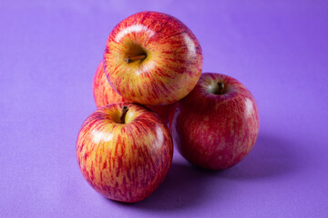 bright red apples on lilac background